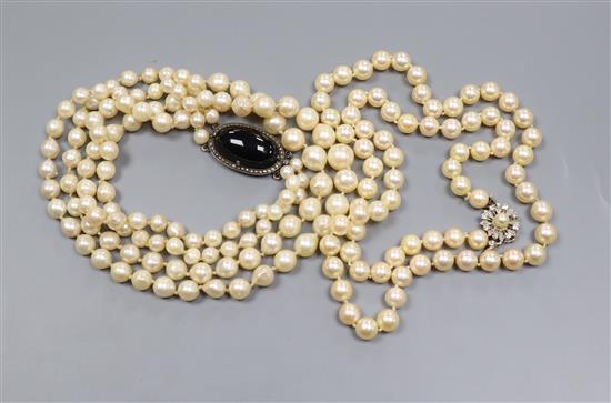 A double strand cultured pearl necklace, with cabochon clasp and a single strand cultured pearl necklace with diamond set clasp.